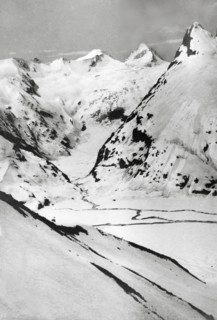 At the peak of Sheshnag Mountain. The snow-capped peaks of Sheshnag Mountain rise up from a valley