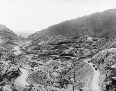 Roads at the mouth of the Khyber Pass. Indian Army trucks and a convoy of camels travel along