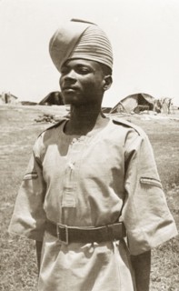 Portrait of an Arab 'onbashi'. An Arab 'onbashi' (corporal) stands to attention, wearing military