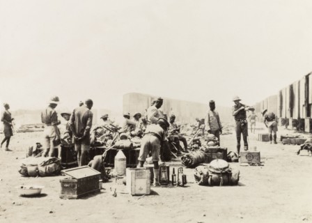 Schutztruppes unload supplies from a train. German and African schutztruppes organise their luggage