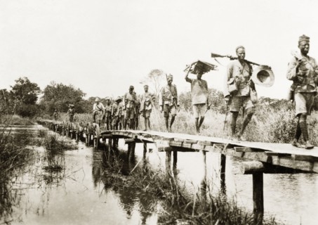 African schutztruppes on the march. A regiment of African schutztruppes march in single file across