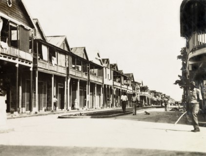 City street in Colon, Panama. Wooden, balconied buildings line the main street running through the