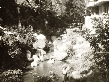 Washing clothes at a plantation house. Workers at a coffee plantation wash their clothes in a