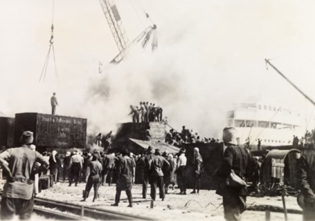 Fire at Jaffa Harbour. Smoke billows from the quayside at Jaffa Harbour as a team of men try to