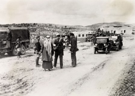 Patrolling a border checkpoint in Arabah. Armed British and Arab police officers patrol a border