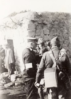 Police and army cooperation' in Samaria. British soldiers and police gather outside a village