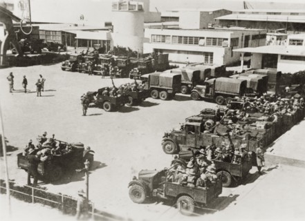 Border guards leave the Levant Fair. Armed border guards climb into their open-topped jeeps as they
