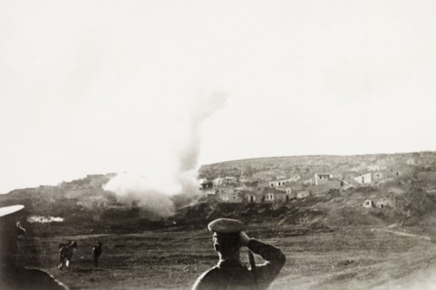 Mortar attack on a Palestinian village. British military officers look on as their mortar shell