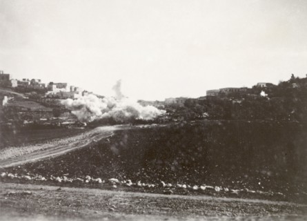 Demolition of a Palestinian house. A cloud of dust engulfs a residential area in Nablus following