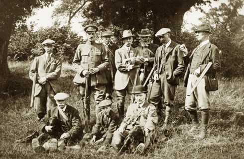 Shooting party at Hardwick Estate. A group of men and a young boy pose for a portrait with rifles