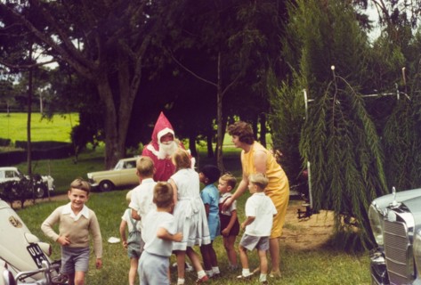 Meeting Father Christmas at Mbarara. A group of European children queue eagerly to meet Father