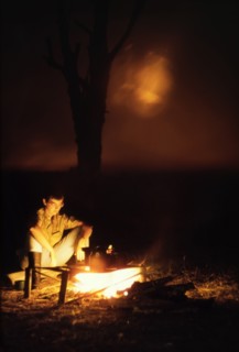 Camp fire at Ishasha River Camp. Elisabeth, the wife of District Forest Officer James Lang Brown,