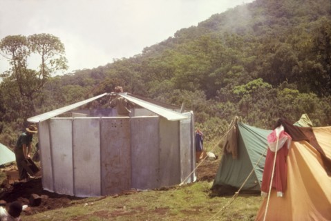 Erecting a 'uniport' on Mount Elgon. Members of an expedition erect a 'uniport' (rondavel) in