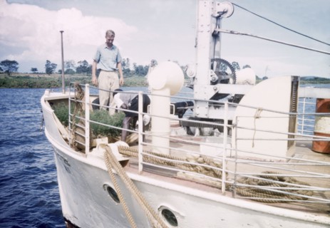 Loading eucalyptus at Port Bell. District Forest Officer James Lang Brown (left) supervises the