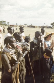 An intrigued audience for the Uganda Police Band'. A group of Pian women and children watch a
