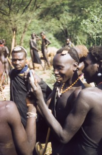 Henry's shaving mirror'. A Suk (Pokot) porter, working with a British forestry survey team, smiles