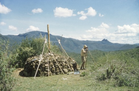 Henry Osmaston surveys Pcholio Peak. Henry Osmaston (Working Plans Officer of the Uganda Forest