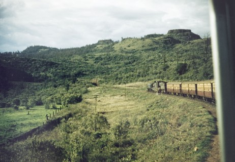 Through the Aberdare Mountains'. A train winds its way through the Aberdare Mountains on the Uganda
