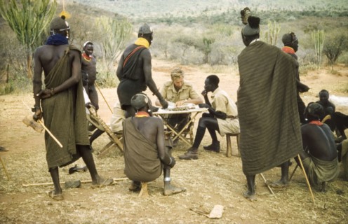 Paying the porters after safari. District Forest Officer James Lang Brown (centre) pays several Suk