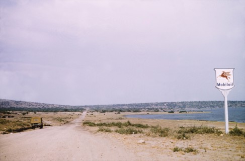 A rural road in Katwe. A Mobiloil sign stands beside a rural road in Katwe to Fort Portal, a