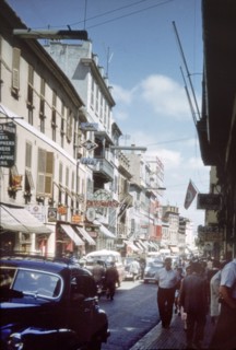A street in Gibraltar'. View along a city street in Gibraltar, bustling with traffic, pedestrians