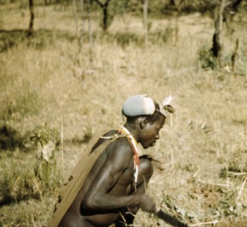 Road builder hard at work. A Karamojong porter helps to construct the Timu Road in Karamoja. Former