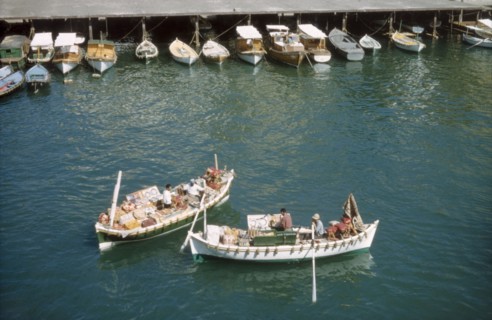 Bumboats at Port Said'. Two bumboats filled with trade wares float in the harbour at Port Said.