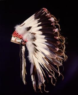 War bonnet of eagle tail feathers, each feather signifying a specific war honour
