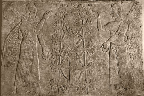 Two winged protective spirits before the sacred tree of life