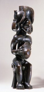 Chief holding a sanza, a musical instrument of the ideophone family, with metal keys and gourd resonator