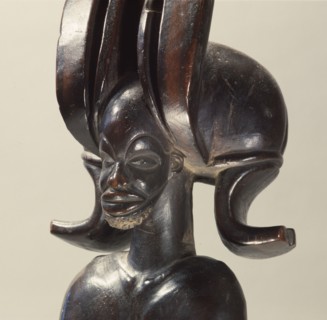 Wood figure of wearing headdress that is characteristic of Chokwe chiefs and also found on important masks