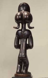 Wood figure of wearing headdress that is characteristic of Chokwe chiefs and also found on important masks