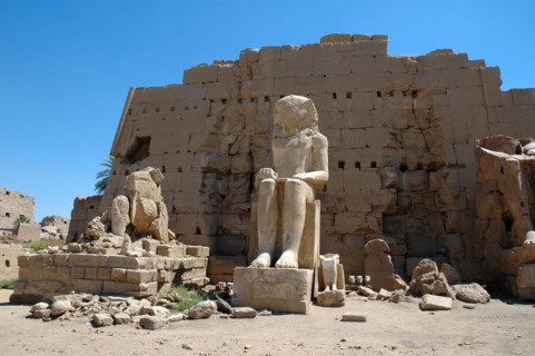 Three seated statues the cetnral on being that of pharaoh Amenophis I