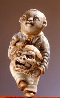 Porcelain netsuke of a lion dancer