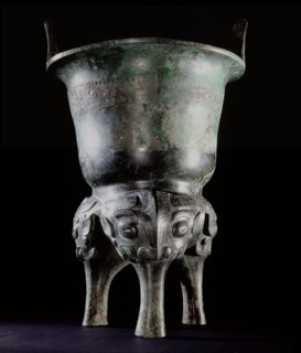 Archaic bronze vessel, Li Ding, with long tao tieh masks on the legs