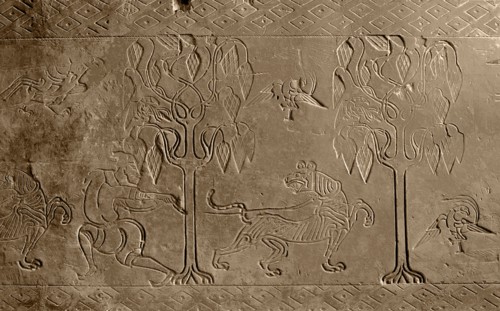 Brick from a tomb structure impressed with design of a man, tree, birds and a tiger