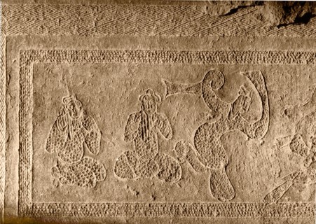 Brick from a tomb structure impressed with a desing depicting players of pan pipes and a dancer