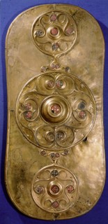 Bronze shield decorated with studs in red glass paste