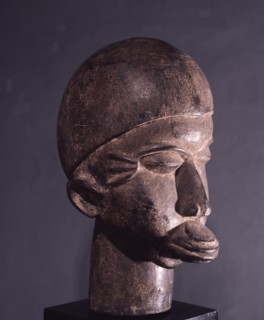 Lobi wooden head with characteristic scarification and lip plug