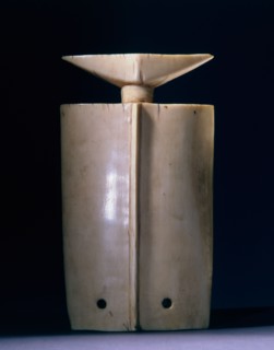 A thungbubiel, an expensive and prestigious ivory ornament, its shape derived from hunters whistles, worn as a pendant by Lobi elders at funerals and festivals