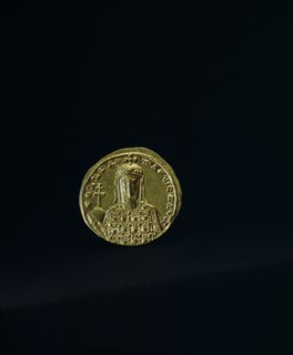 A gold solidus minted in 945 with the figure of Emperor Constantine V11 holding an orb surmounted by a cross