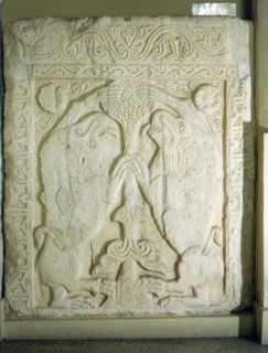 A slab carved in relief with a Tree of Life flanked by two lions