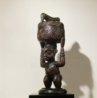 A bowl supported by a standing male figure and surmounted by a bird