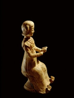 Figure of a seated woman reading a book