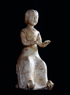 Figure of a seated woman reading a book