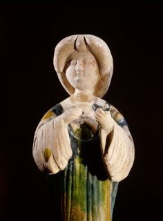 Pottery figure of a court lady holding a bird
