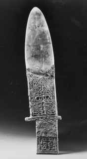 Ko axe with bronze handle and jade blade, incised with designs including an animal mask