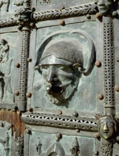 Detail of the bronze door of the Basilica of San Zeno which is decorated with 48 panels illustrating biblical stories and the lives of St Peter, St Paul, St Zeno, St Helena among others, and items con...