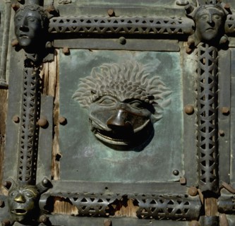 Detail of the bronze door of the Basilica of San Zeno which is decorated with 48 panels illustrating biblical stories and the lives of St Peter, St Paul, St Zeno, St Helena among others, and items con...