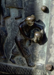 Detail of the bronze door of the Basilica of San Zeno which is decorated with 48 panels illustrating biblical stories and the lives of St Peter, St Paul, St Zeno, St Helena among others, and items con...